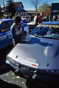 Yorgi Bittner reads notes before navigating for Selcuk Karamaoglu in his Mitsubishi Eclipse.