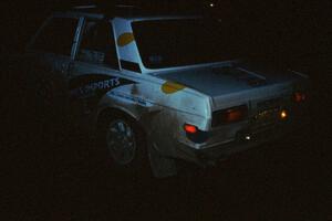 Mike Whitman / Dave White await the start of a night stage in almost complete darkness in their Datsun 510.