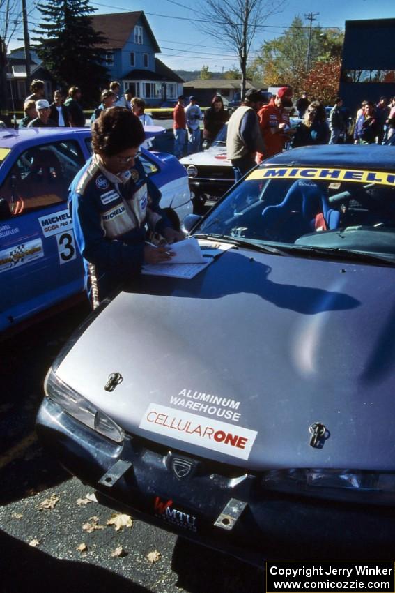 Yorgi Bittner reads notes before navigating for Selcuk Karamaoglu in his Mitsubishi Eclipse.