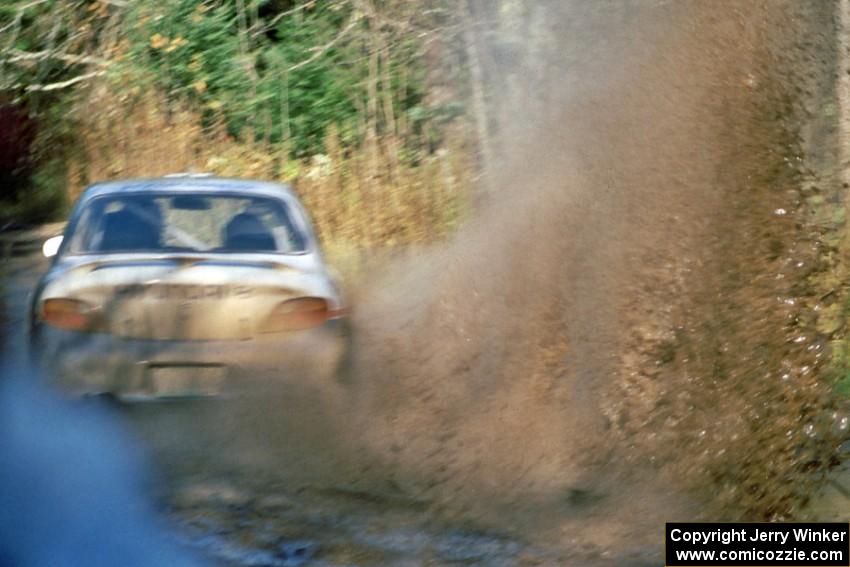 Paul Choinere / John Buffum in the Hyundai Elantra hit a huge puddle at speed before the final bridge on the Menge Creek stage.
