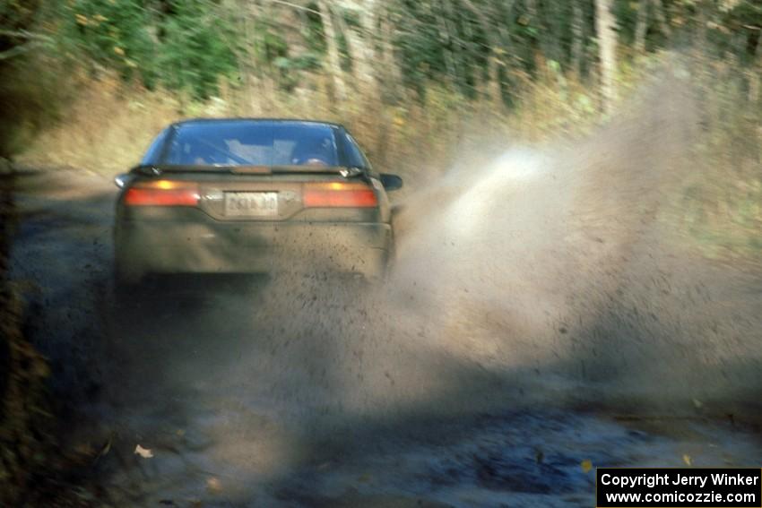 The Selcuk Karamanoglu / Yorgi Bittner Mitsubishi Eclipse hits a puddle before the Menge Creek bridge at speed.