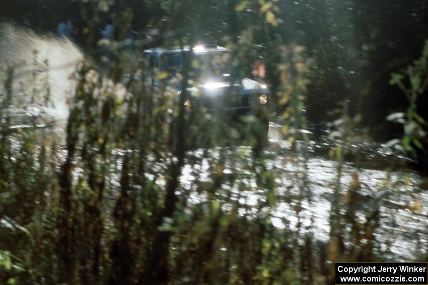 Mike Whitman / Dave White blend in with the fall scenery as they hit a puddle on Menge Creek 1 in their Datsun 510.