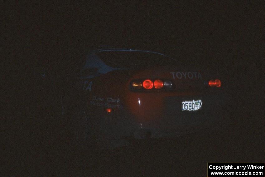 The Ralph Kosmides / Joe Noyes Toyota Supra awaits the start of the stage in almost complete darkness.