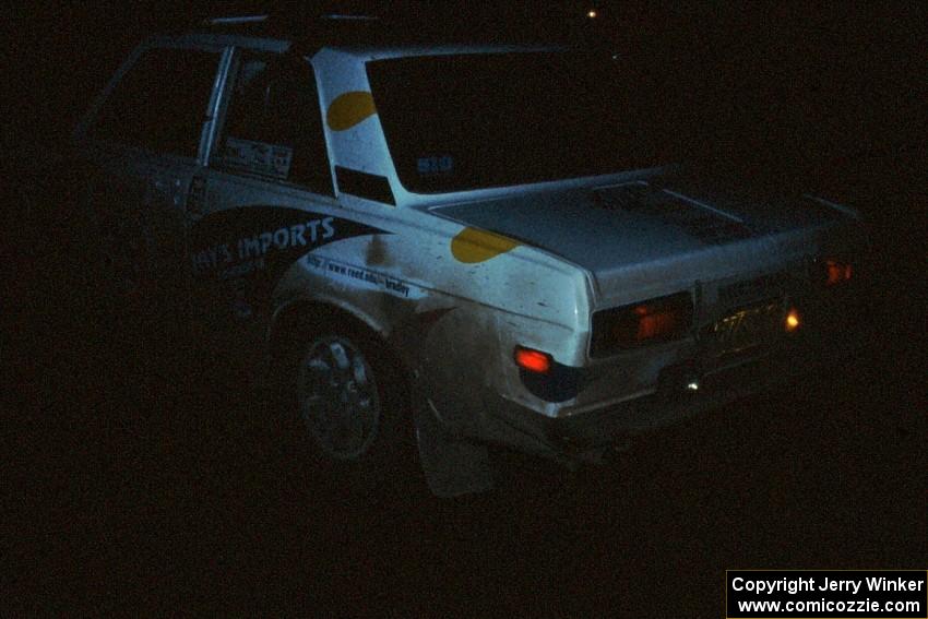 Mike Whitman / Dave White await the start of a night stage in almost complete darkness in their Datsun 510.