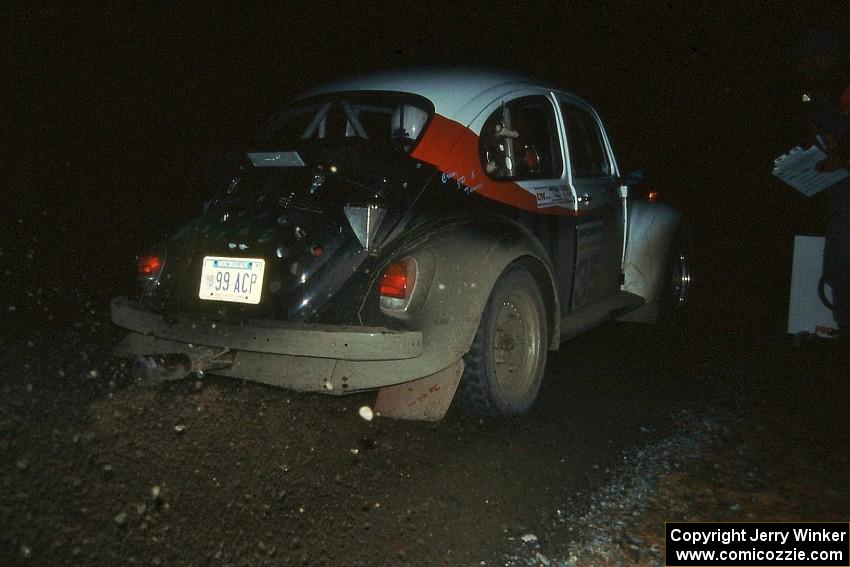 Reny Villemure / Mike Villemure blast out of the start of a night stage in their VW Beetle.