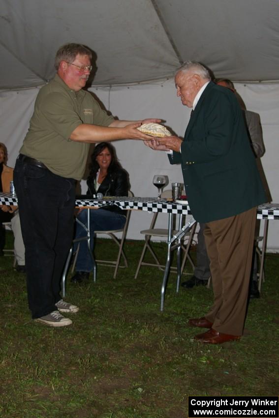 Tim Winker hands Chris Economaki a birthday cake