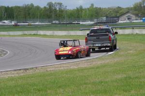Don Haaversen's E Production Datsun 2000 gets flat-towed around the track
