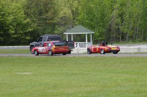 Brooke Fairbanks' STU VW Scirocco passes the flat-towed E Production Datsun 2000 of Don Haaversen