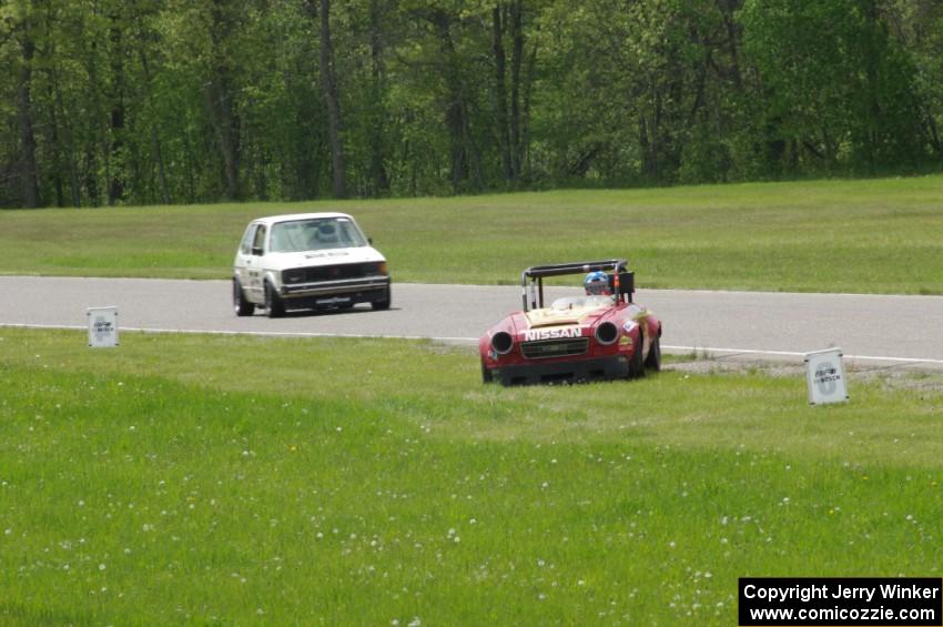 Don Haaversen's E Production Datsun 2000 pulls off the track before turn 4 as Jimmy Griggs' ITB VW Rabbit passes