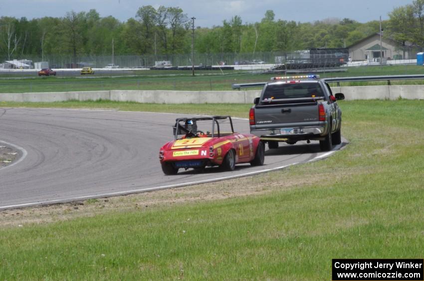 Don Haaversen's E Production Datsun 2000 gets flat-towed around the track