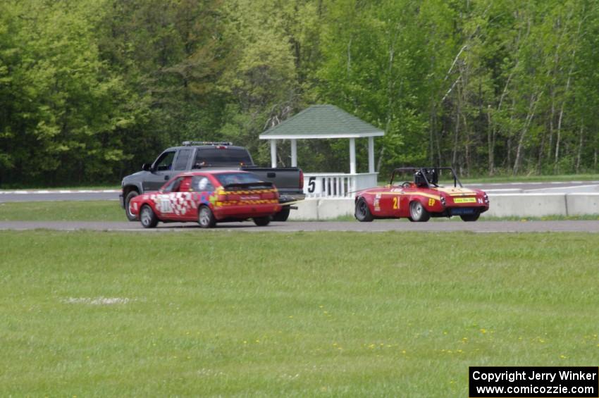 Brooke Fairbanks' STU VW Scirocco passes the flat-towed E Production Datsun 2000 of Don Haaversen