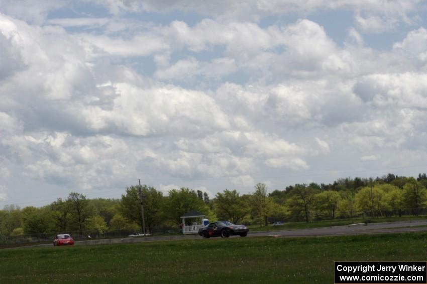 Sean Maloney's STO Chevy Corvette and Shannon Ivey's ITE Porsche 911SC head through turn 4