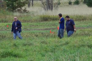 Dan Drury and two others walk the course