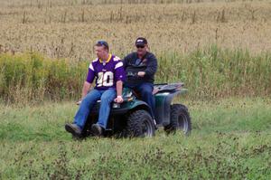 Mark Utecht drives the ATV while Brian Chabot checks for things on the racing line
