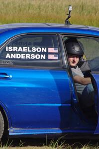 Tim Anderson sits in the passenger seat of his Subaru WRX STi. Dave Goodman is the driver.