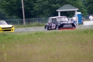 Terry Orr's GTL Austin Mini-Cooper leads Tim Homes' E Production Datsun 240Z out of turn 4
