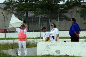 Corner workers at turn 6 display the white flag for an emergency vehicle on the track