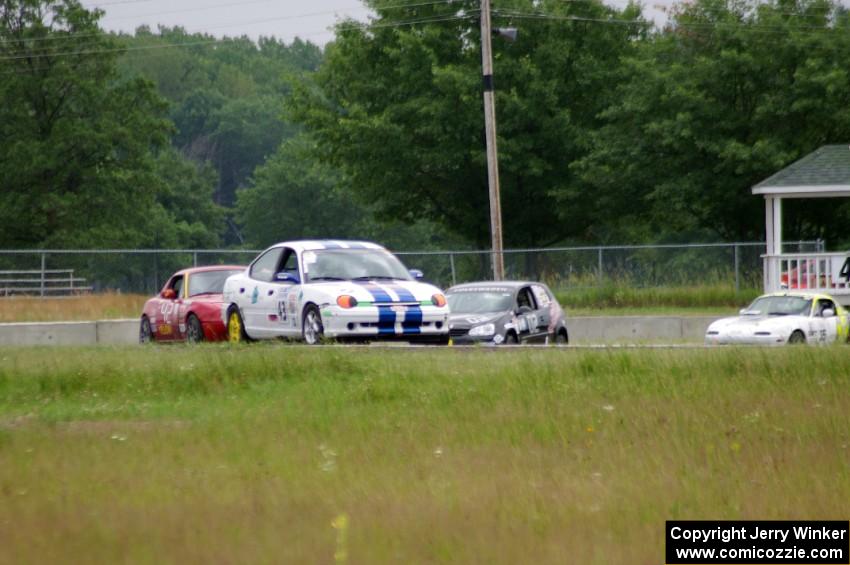 John Glowaski's ITA Dodge Neon ACR, Greg Youngdahl's Spec Mazda Miata, David Daly's SCC VW Rabbit and Dan Corgard's Spec Miata