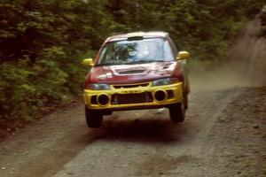 Dennis Martin / Kim DeMotte Mitsubishi Lancer Evo IV catches air on a jump on SS13, Indian Creek.