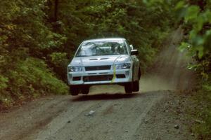 Ron Nelson / Bill Montgomery Mitsubishi Lancer Evo VII catches air on a jump on SS13, Indian Creek.