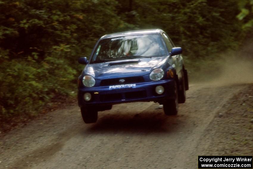 Mark Utecht / Jeff Secor Subaru WRX catches air on a jump on SS13, Indian Creek.