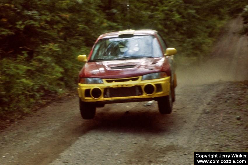 Dennis Martin / Kim DeMotte Mitsubishi Lancer Evo IV catches air on a jump on SS13, Indian Creek.