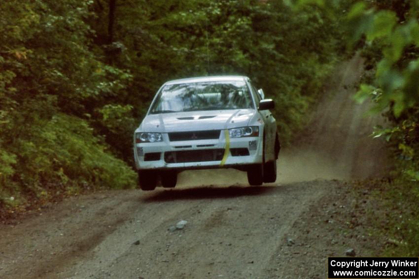 Ron Nelson / Bill Montgomery Mitsubishi Lancer Evo VII catches air on a jump on SS13, Indian Creek.