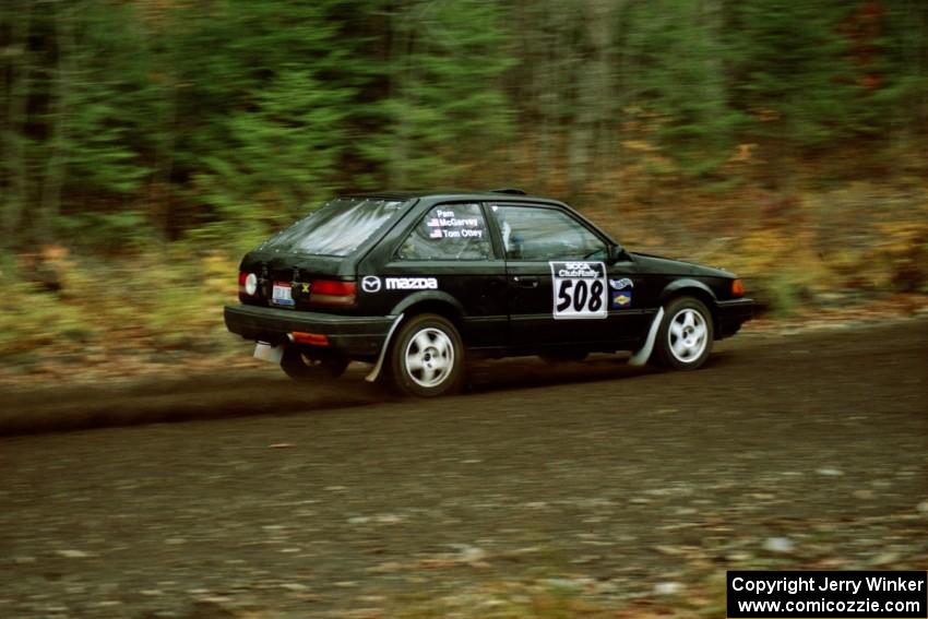 Tom Ottey / Pam McGarvey Mazda 323GTX near the start of SS1, Herman.