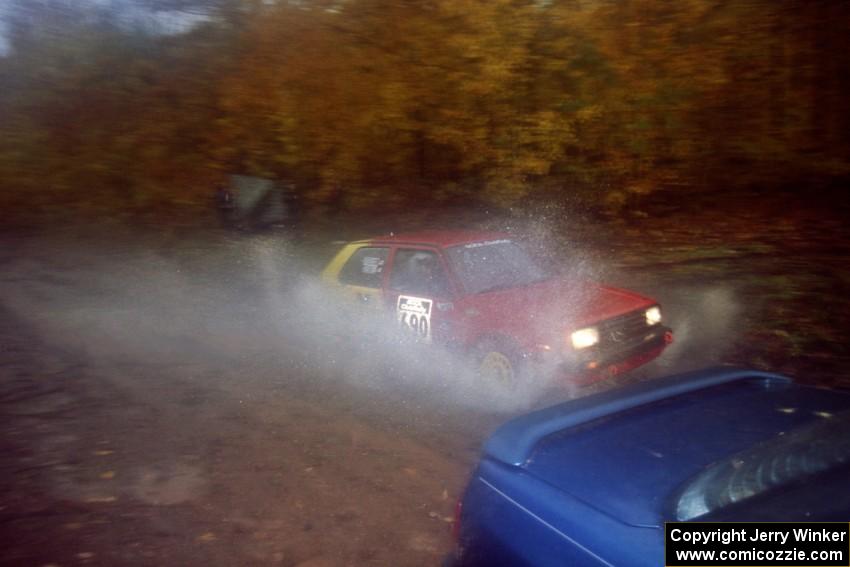 Carl Seidel / Eric Iverson VW Golf passes the waterlogged Erick Murray / Barry Ptak Subaru Legacy on SS8, Gratiot Lake.