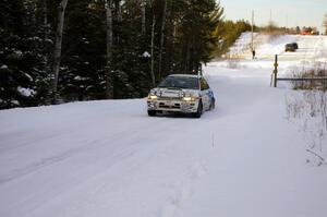 Henry Krolikowski / Cindy Krolikowski fly down a straight at sundown on the ranch stage in their Subaru WRX.