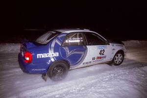 The Eric Burmeister / Dave Shindle Mazda Protege MP3 drifts through the first corner of the evening running of the ranch stage.