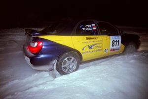 The Wojtek Okula / Adam Pelc Subaru WRX drifts through the first corner of the evening running of the ranch stage.