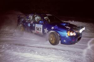 The William Bacon / Peter Watt Subaru WRX STi drifts through the first corner of the evening running of the ranch stage.