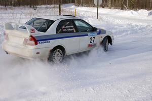 Chris Gilligan / Joe Petersen set up for a 90-left on the first stage of day two in their Mitsubishi Lancer Evo IV.