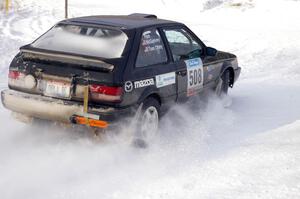 Tom Ottey / Pam McGarvey Mazda 323GTX at a 90-left on the first stage of day two.