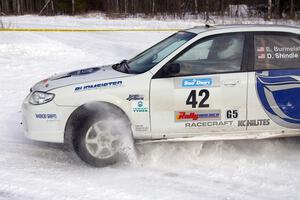 Eric Burmeister / Dave Shindle Mazda Protege MP3 kicks up snow at a 90-left on the first stage of the morning.