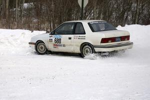 Greg Woodside / Tom Woodside get the back end loose on a right-hander in their Dodge Shadow.