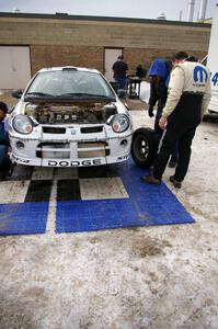 Doug Shepherd examines the left-front tire of his Dodge SRT-4 at the final service in Atlanta. He shared the car with Bob Martin