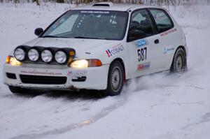 Matt Johnston / Alex Kihurani Honda Civic exit a hairpin at dusk on day two.