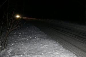 A car comes into the finish of the Hungry 5 stage at night.