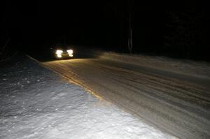 A car comes into the finish of the Hungry 5 stage at night.