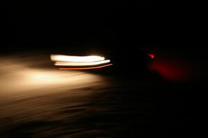 A car crosses the finish of Hungry 5 at night.