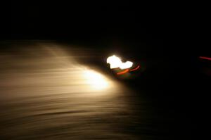 A car crosses the finish of Hungry 5 at night.