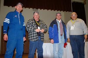 Dave Parps (L) and eventmaster Don Rathgeber (R) pose with workers who won the Greer Tire raffle.