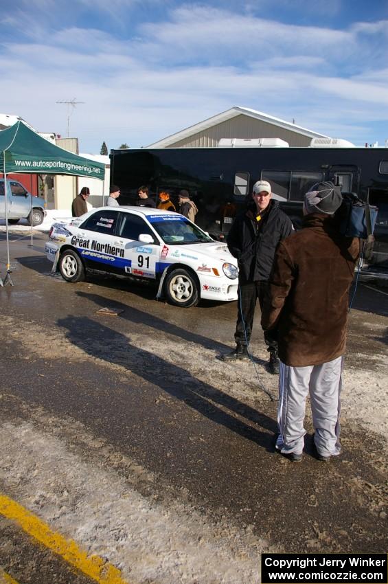 Jonathan Bottoms is interviewed in front of his Subaru WRX in Lewiston prior to the start. Carolyn Bosley was his navigator.