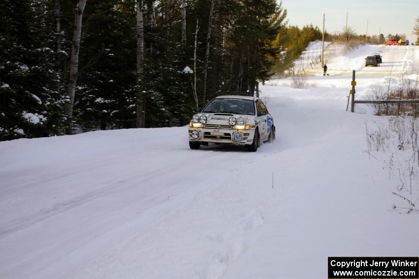 Henry Krolikowski / Cindy Krolikowski fly down a straight at sundown on the ranch stage in their Subaru WRX.