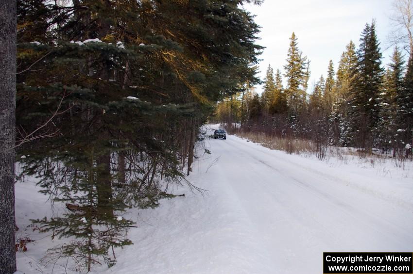 Tom Ottey / Pam McGarvey Mazda 323GTX at speed on a straight on the ranch stage.