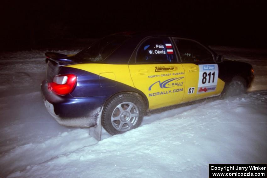 The Wojtek Okula / Adam Pelc Subaru WRX drifts through the first corner of the evening running of the ranch stage.