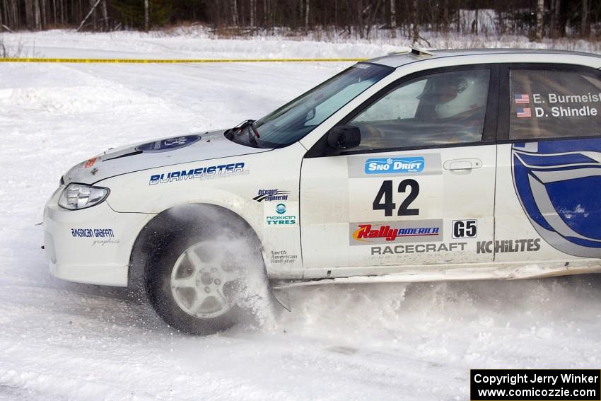 Eric Burmeister / Dave Shindle Mazda Protege MP3 kicks up snow at a 90-left on the first stage of the morning.