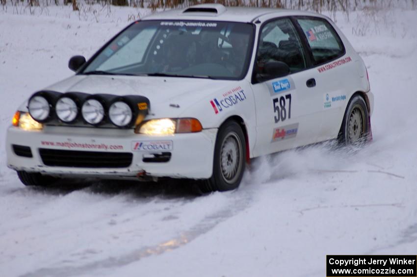 Matt Johnston / Alex Kihurani Honda Civic exit a hairpin at dusk on day two.